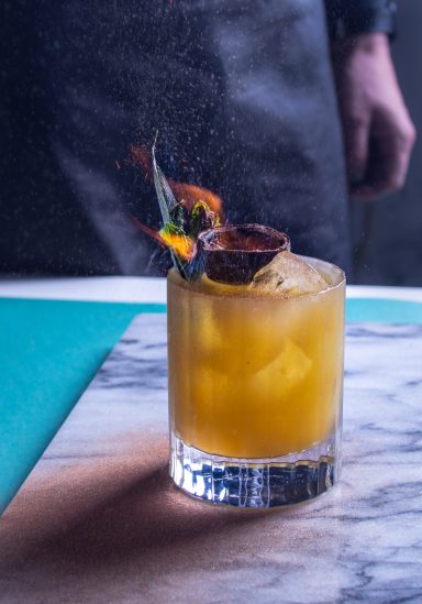 Flaming Garnish atop an Orange cocktail, photographed by Leeds-based food photographer Elizabeth Wood.