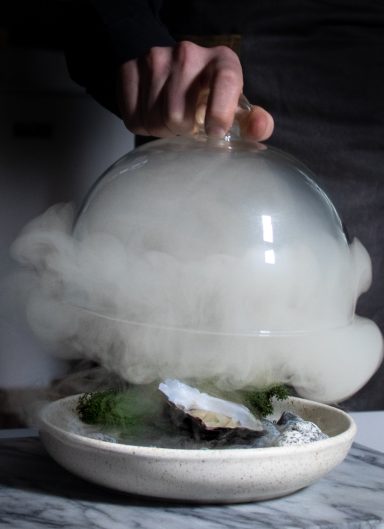 A beautifully plated gourmet oyster with smoked cloche, photographed by Leeds-based food photographer Elizabeth Wood.