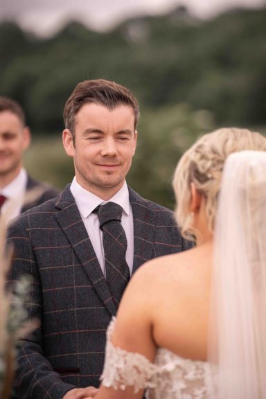 Candid wedding moment by Elizabeth Wood, female wedding photographer